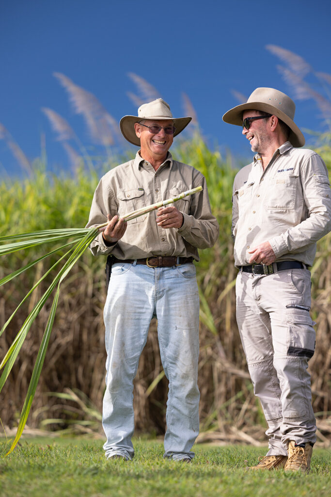 Sugar cane farmer laughing with Sunwater employee
